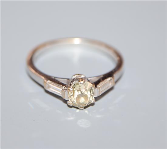 A modern 18ct white gold and fancy yellow single stone diamond ring, with baguette cut diamond set shoulders, size Q.